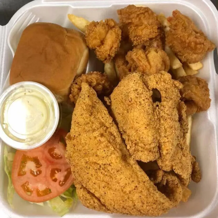 Fried seafood combo with fries and salad at Tate Cove Seafood, a Fast-Food Restaurant in Ville Platte